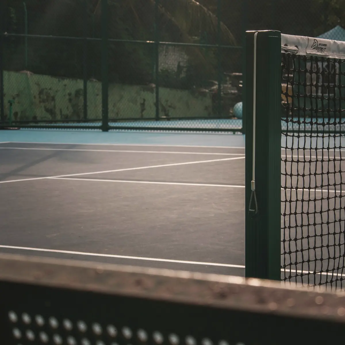 An empty court seen through the fence