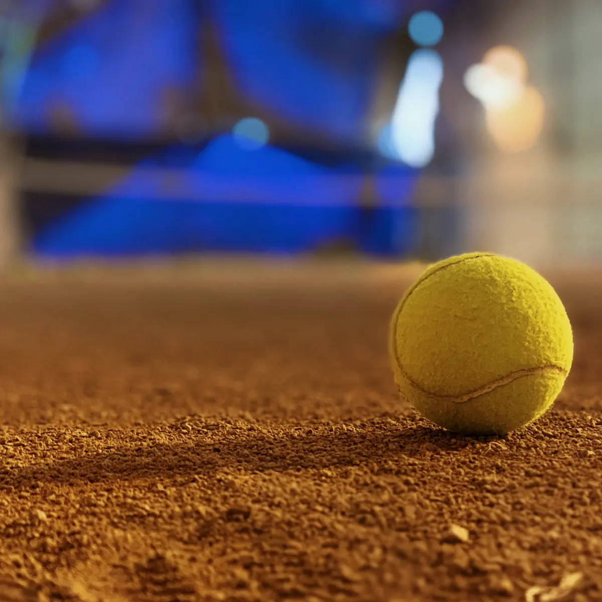 Tennis ball on a clay court
